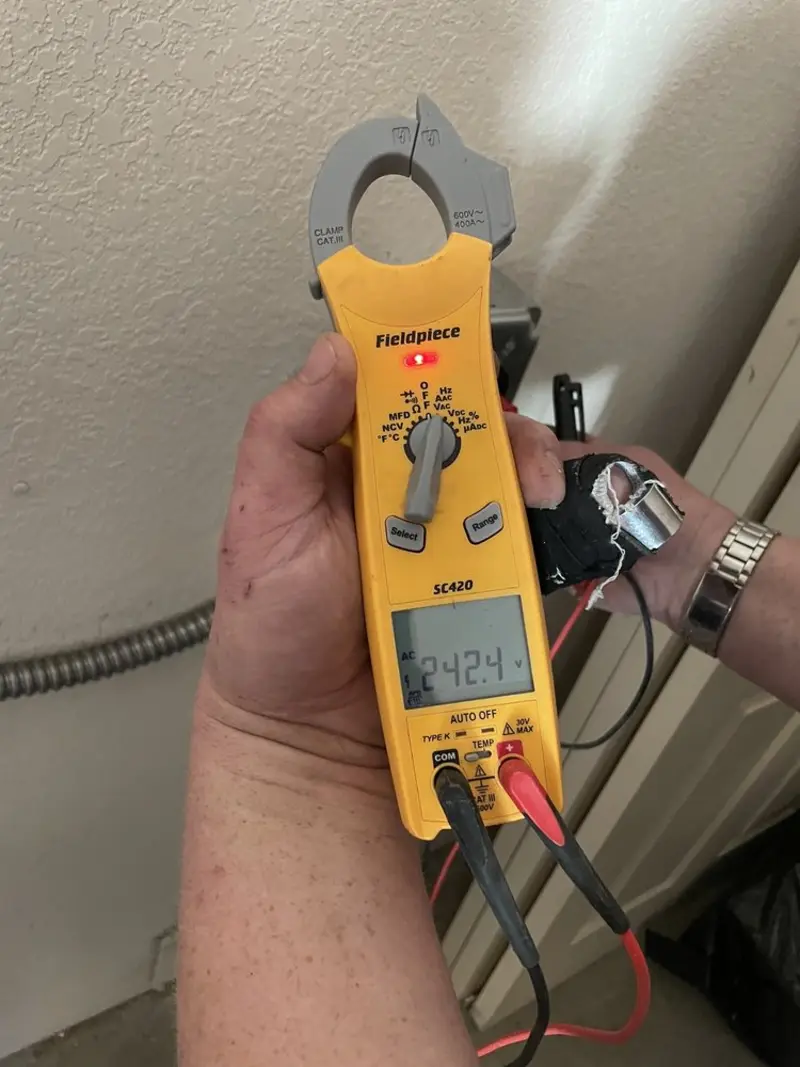 Voltage testing with clamp meter during Recessed Lighting Installation in Streator